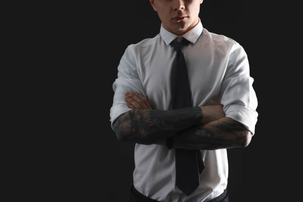 istock Young man with tattoos on black background, closeup. Space for text 1428728627