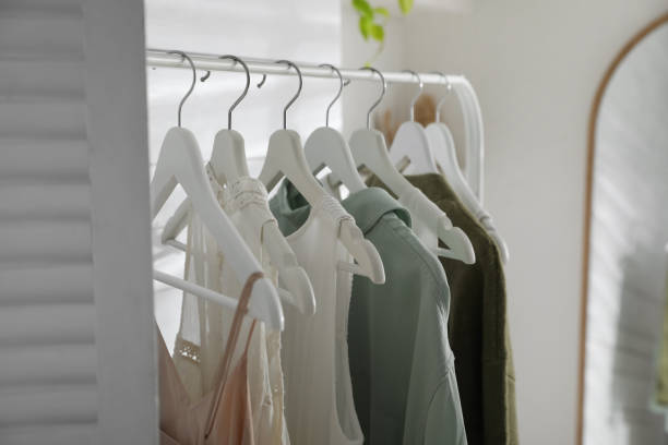 istock Rack with different stylish clothes in dressing room, closeup 1428732972