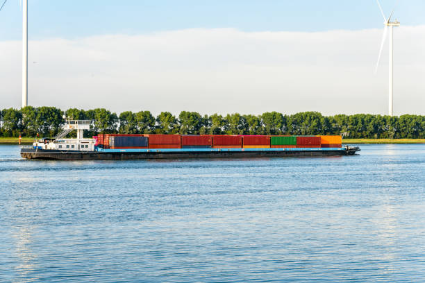 istock Cargo barge carrying containers on a canal 1428734146