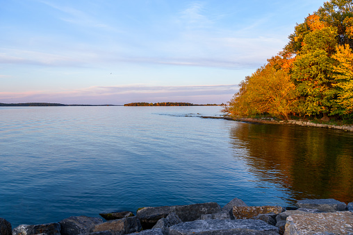 View of a lake at dusk at sunset in autumn. Fall foliage. Wolfe Island, ON, Canada.