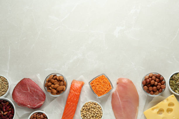 istock Set of products rich in amino acids on light grey table, flat lay. Space for text 1428737103