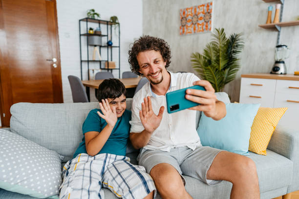 istock Father And Son Having A Video Call Using Smart Phone 1428737450