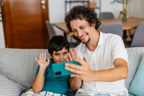 istock Father And Son Having A Video Call Using Smart Phone 1428737472