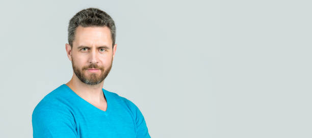 istock Man face portrait, banner with copy space. handsome mature man with beard on grey background, fashion. 1428738557