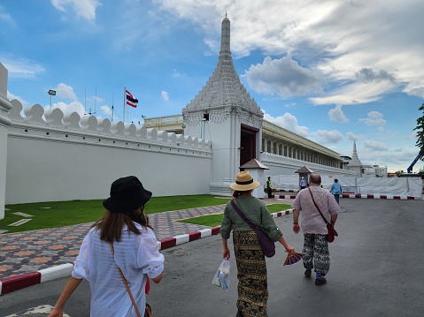 Tourists are on their way to visit The Temple of the Emerald Buddha, a temple built in the Grand Palace, containing the Emerald Buddha, a meditative Buddha image.Bangkok, Thailand, 2022-09-04