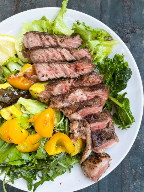 istock Grilled beef with healthy salad on white plate; top view. 1428744373