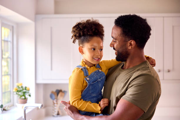 istock Loving Daughter Hugging Army Father In Uniform On Home Leave In Kitchen 1428745124
