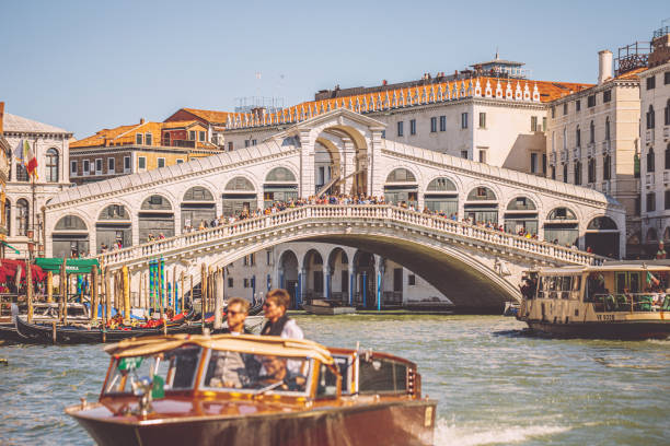 Tourists enjoying water taxi services in Venice Venice, Italy - September 21, 2022: Tourists admire the sights of the city while sitting in a sightseeing water taxi. In the background, a major tourists attraction, Ponte de Rialto that is the oldest of the four main bridges over the Grand Canal in Venice is visible.
Venice is built on a group of 118 small islands separated by canals that are linked together by over 400 bridges. watertaxi stock pictures, royalty-free photos & images