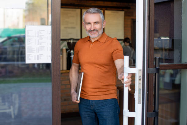 istock Mature confident man with notebook at the cafe entrance 1428747632