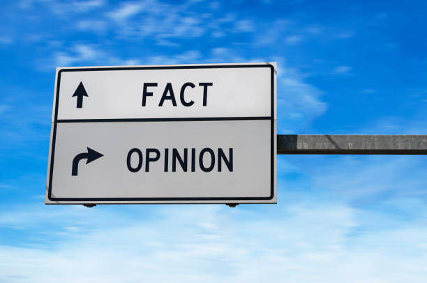 Fact versus opinion road sign. stock photo