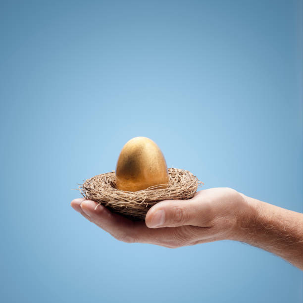 istock Retirement savings pension golden nest egg in a mans hand 1428749726