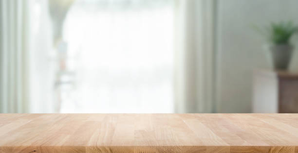 istock Empty wood table top on blur abstract home room,window view. 1428753862
