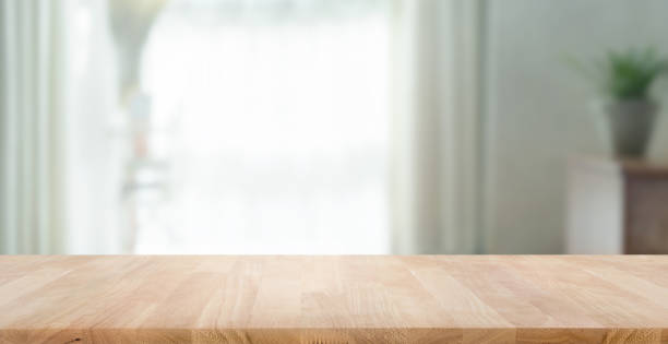 Empty wood table top on blur abstract home room,window view. stock photo