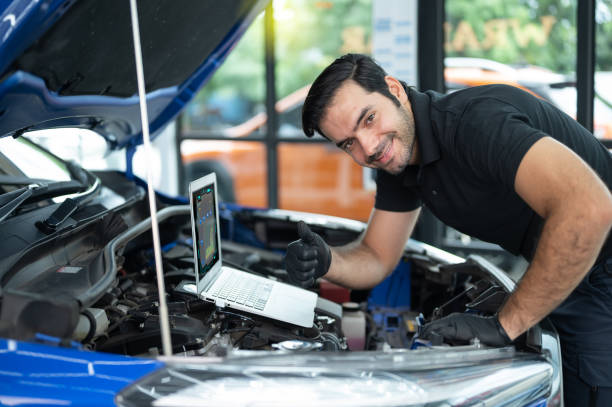 istock Mechanic Asian man close up using laptop computer and diagnostic software to tuning fixing repairing car engine automobile vehicle parts using tools equipment in workshop garage support services 1428754934