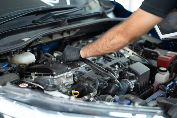 istock Mechanic Asian Arab man close up using laptop computer and diagnostic software to tuning fixing repairing car engine automobile vehicle parts using tools equipment in workshop garage support services 1428754997