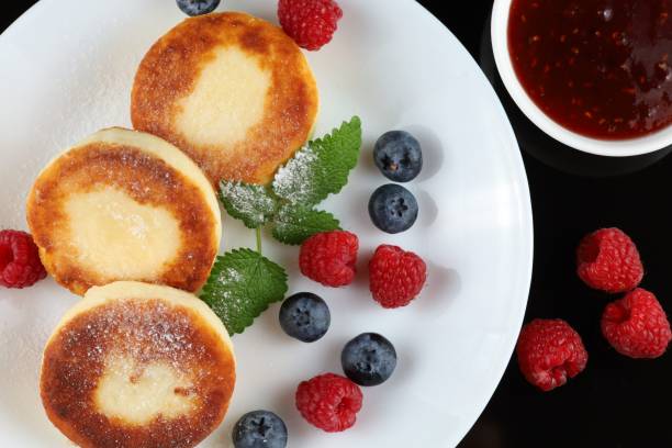 istock Cottage cheese fritters served with fruit jam. 1428755152