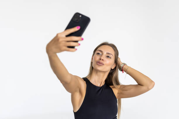 istock Pretty young happy woman making selfie on smartphone on white background 1428756864