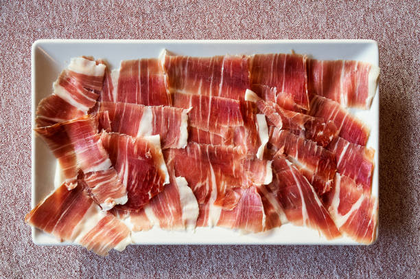 appetizer plate of freshly sliced iberian acorn-fed acorn-fed ham stock photo