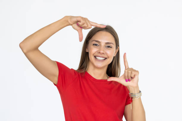 istock Young woman framing photograph on white background 1428760905