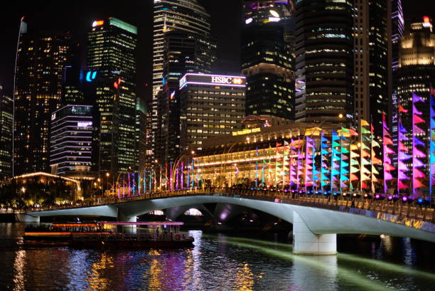 istock Singapore City at night with rainbows lightings bridge view 1428763093
