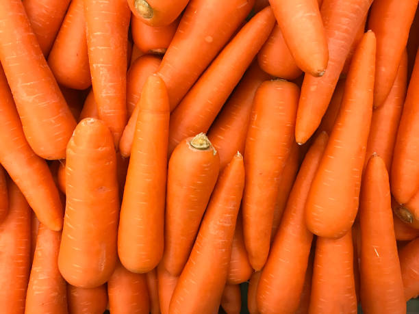 primo piano dell'immagine strutturata delle carote negli scaffali dei grandi magazzini o nei supermercati - carrot foto e immagini stock