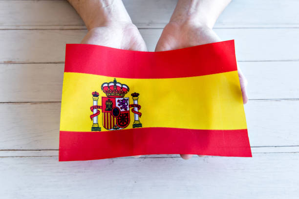 Hands holding the flag of Spain