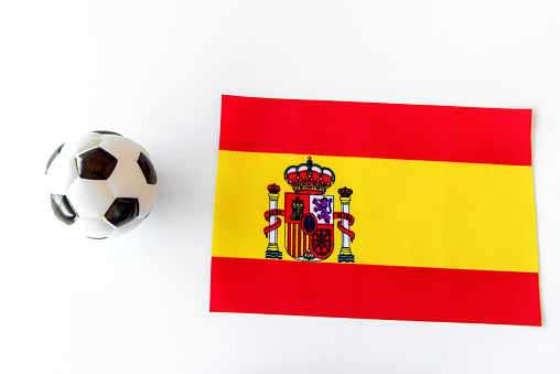 Soccer ball and Spain flag on white background