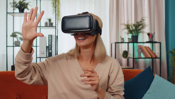 istock Young girl use virtual reality headset glasses at home play 3D video game making gestures with hands 1428765692