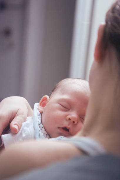 istock Mother putting her baby to sleep 1428766007