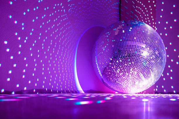 istock Disco ball reflecting purple light. Holidays concept. Copy space. 1428766357