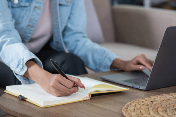 istock African woman, American, using laptop computer and wearing headphones for online learning. 1428768175