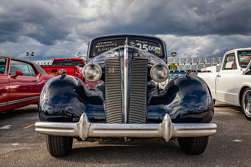 Daytona Beach, FL - November 28, 2020: Low perspective front view of a 1937 Buick Century Series 60 Model 64 Touring Sedan at a local car show.