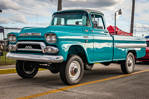 Daytona Beach, FL - November 28, 2020: Low perspective front corner view of a 1958 GMC 100 Pickup Truck with NAPCO Four Wheel Drive Conversion at a local car show.