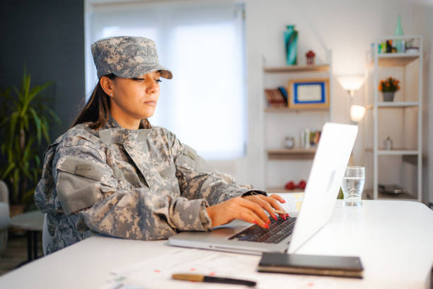 istock Female soldier working on laptop at home 1428773834