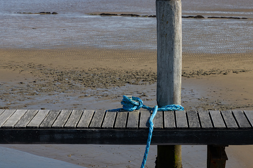 Wooden pier during low tide in the wadden sea