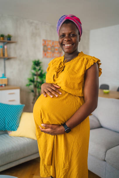 Cheerful pregnant woman at home stock photo