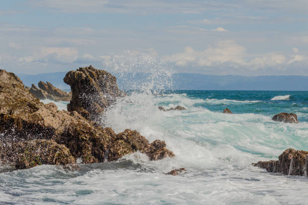 Sea wave high crash at rock stone stock photo