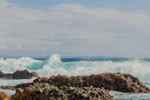 Sea wave crash at rock stone stock photo