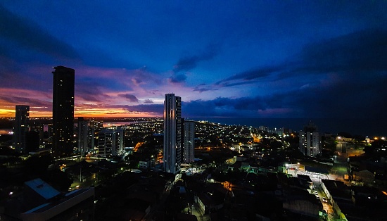 The skyline of the city of Natal, Rio Grande do Norte, Brazil. Night cityscape and sunset light on the horizon. Buildings and street lights.