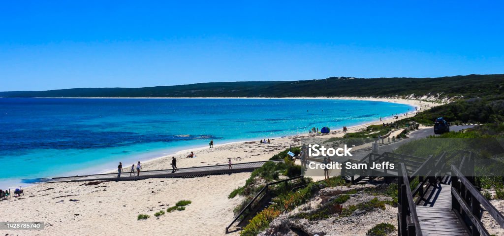 Hamlin Bay, Western Australia Taken around 1pm on a beautiful day. Strong and deep blues from the ocean and skies. A long stretching beach with glorious golden sand. Sweeping green hills around the bay with protected beach bush. Atmosphere Stock Photo