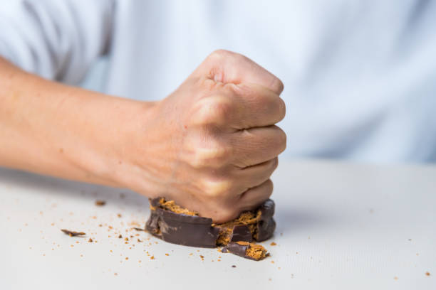 fist crushing and smashing a chocolate, candy and chocolate