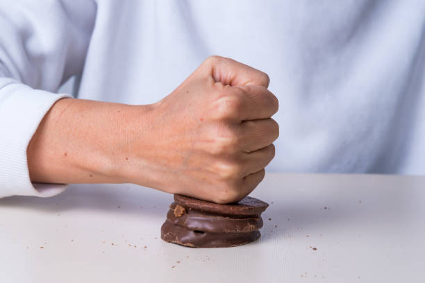 istock hand crushing a chocolate, sugar, not suitable for diabetics, chocolate alfajor 1428787062