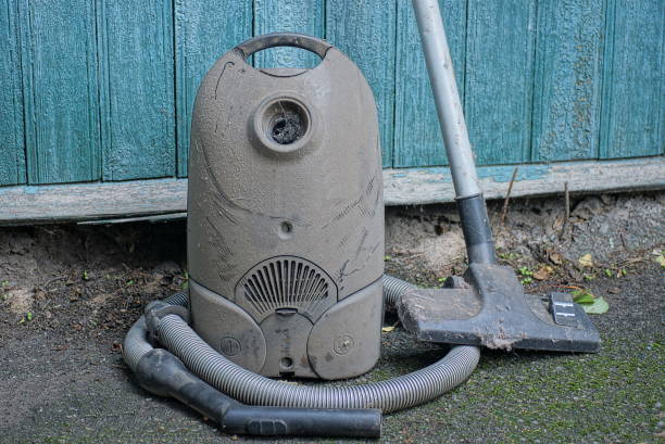 istock one old dirty black vacuum cleaner in gray dust with hose 1428788342