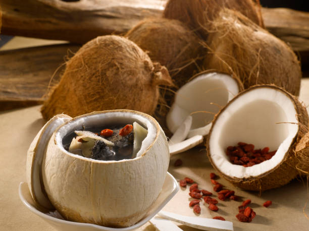 istock Whole Coconut with Black Chicken Soup served in a Coconut pot isolated on table side view 1428789599