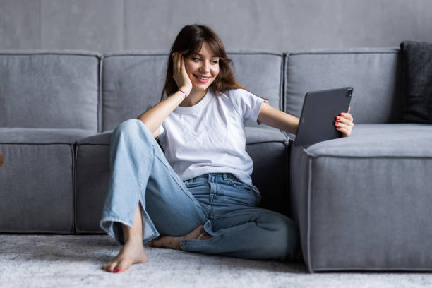 istock Young woman holding a tablet at home 1428790787