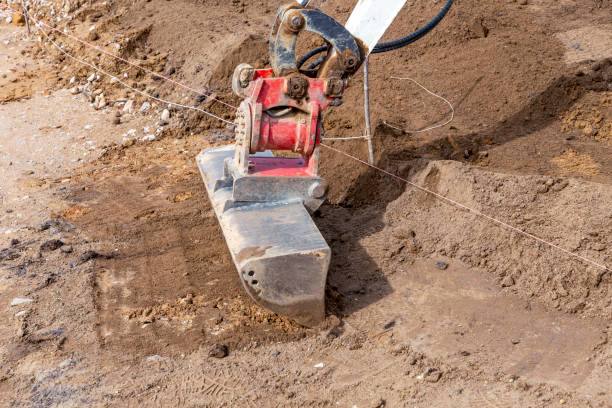 istock levelling fresh potting soil with the scoop of a digger 1428790906