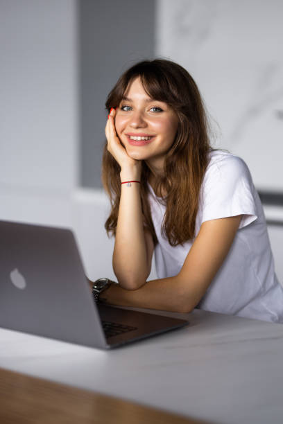 istock Happy young woman using laptop in cook room 1428790928