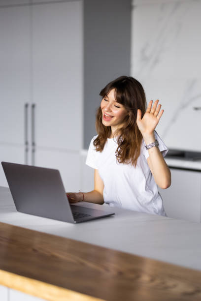istock Smiling young woman making video call and heaving a breakfast in her kitchen. 1428791867