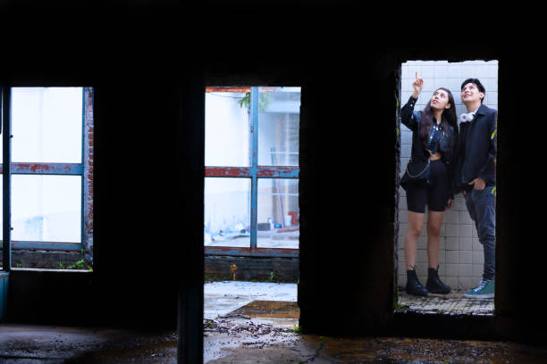 Young people discovering an old building in the light and dark