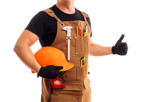 istock Contractor worker or carpenter in apron with tools and helmet holding thumbs up 1428794444